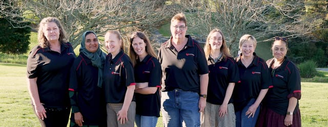 The Manawanui coaching team standing together outdoors