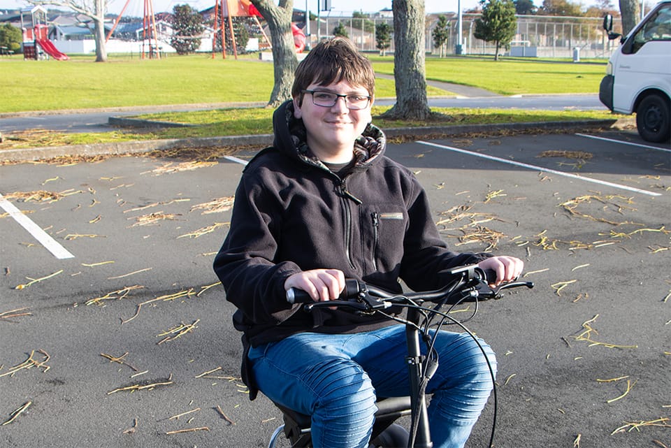 Nathan on his scooter in a car park