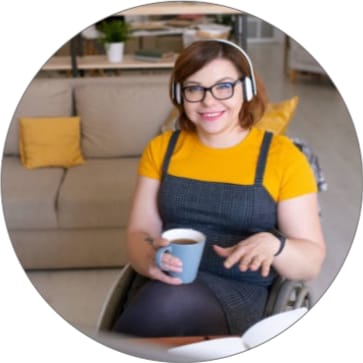 Smiling woman in a yellow top holding a mug