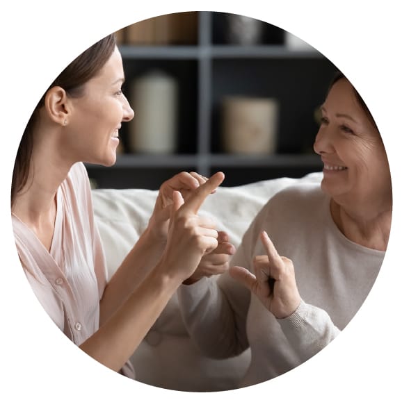 Two women talking to each other in sign language
